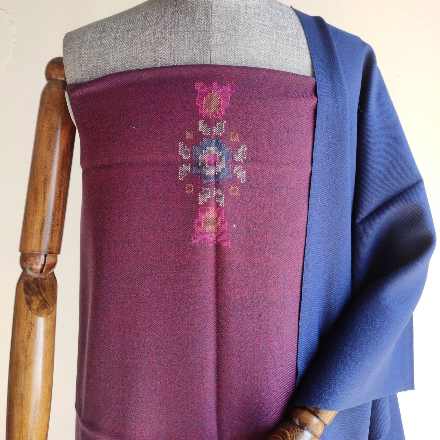 Mannequin wearing a purple women's woolen suit with floral patterns 