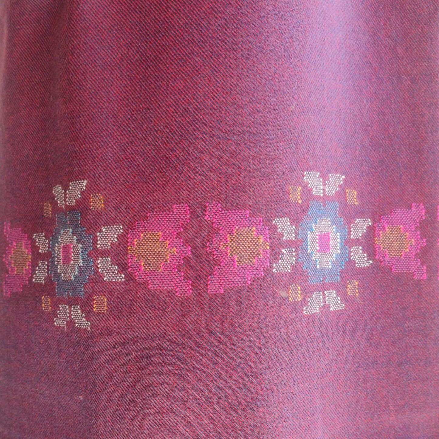 Close-up of a women's woolen suit with embroidered floral patterns