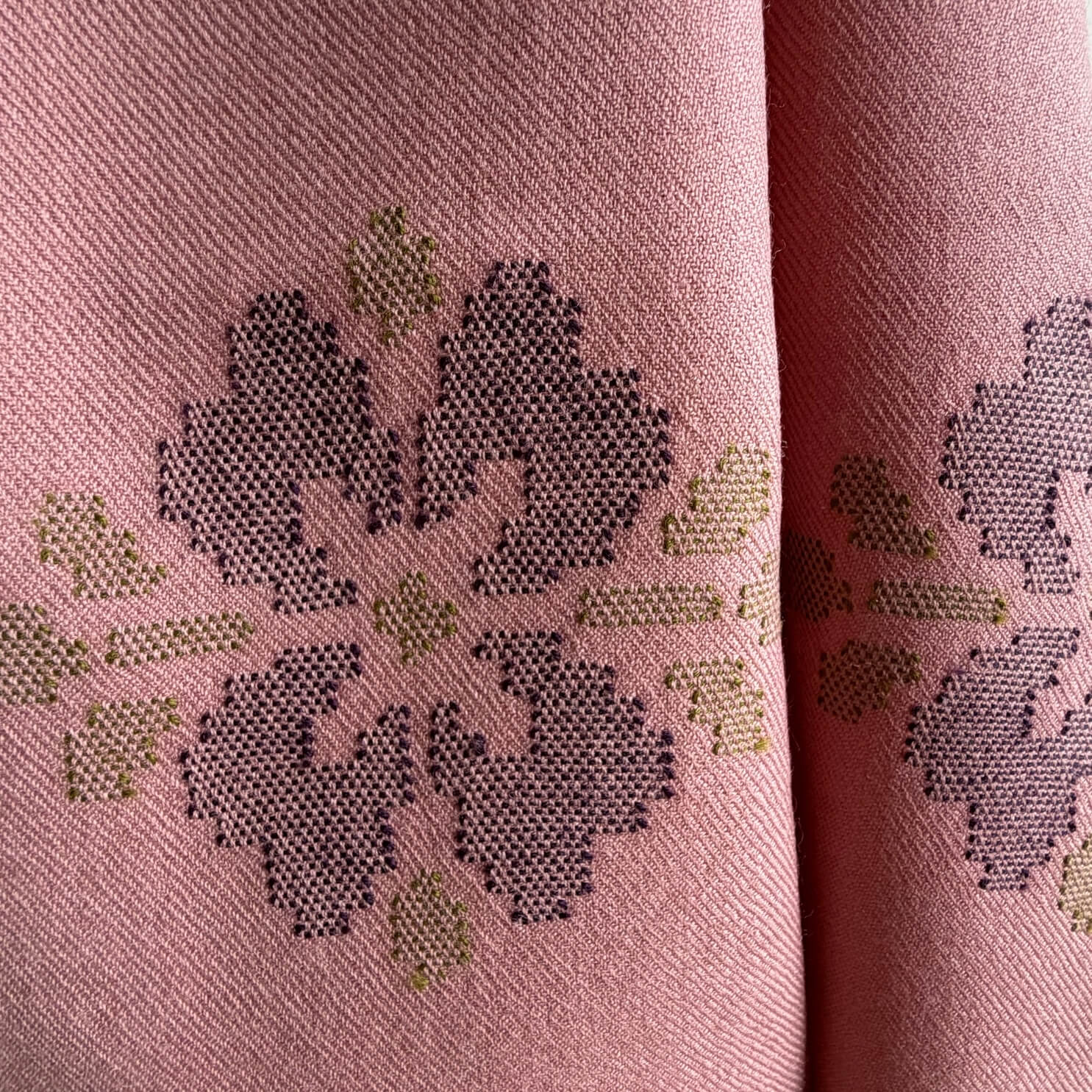 close up of motif on dusty pink merino wool stole

