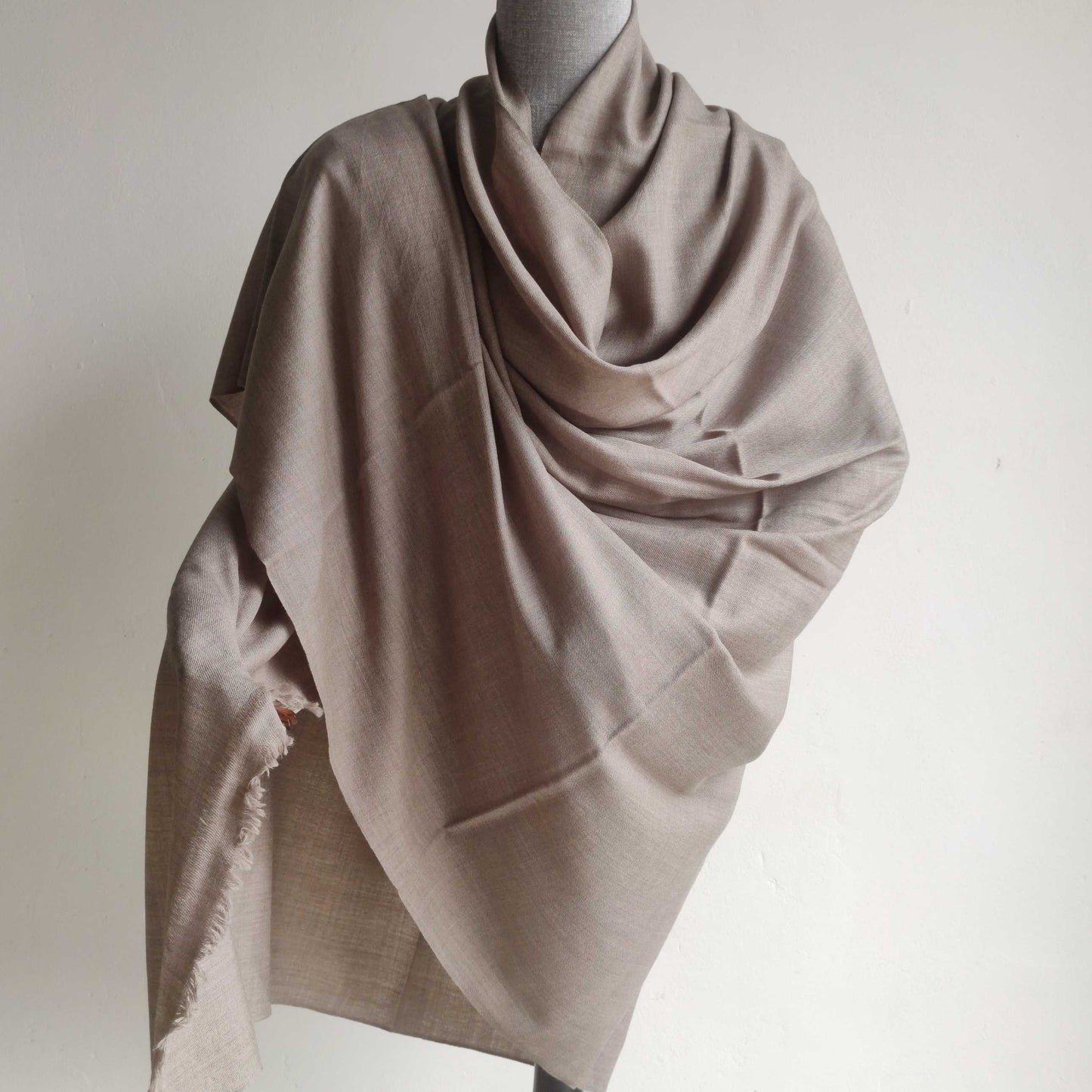 Beige Men's shawl(loi) draped over a mannequin against a plain background