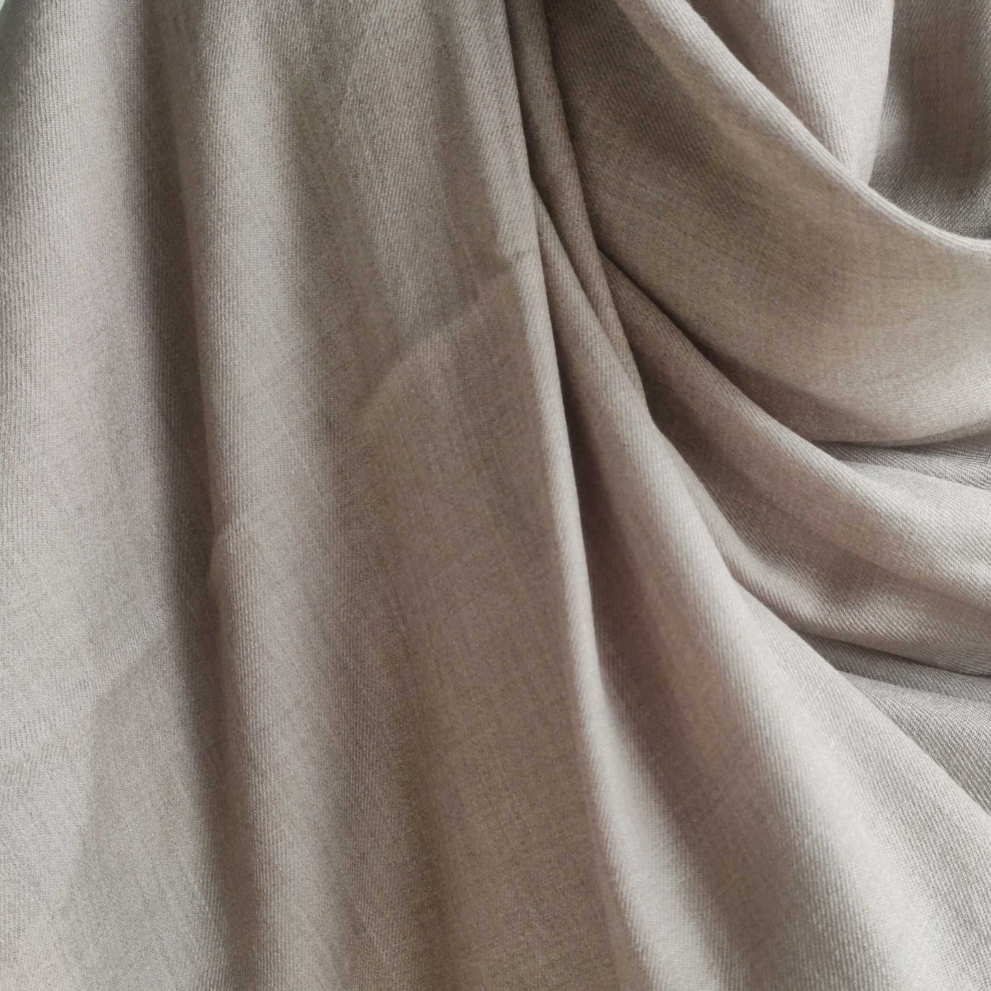 Close-up of beige men's shawl(loi) with folds