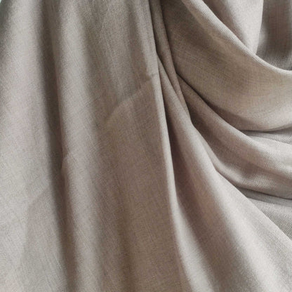 Close-up of beige men's shawl(loi) with folds