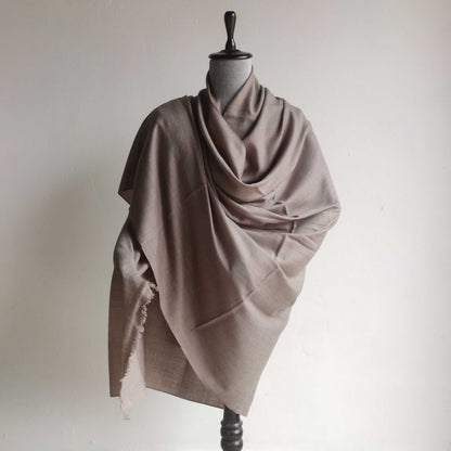 Beige  Men's shawl draped over a mannequin against a plain background