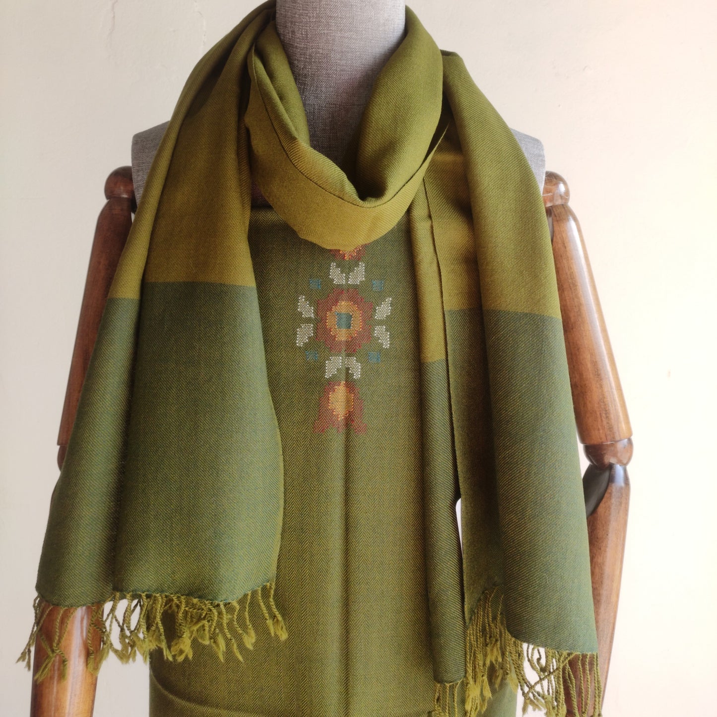 Green stole and suit with embroidery on a mannequin