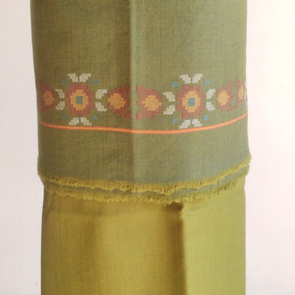 Green women's woolen with floral embroidery on a white background