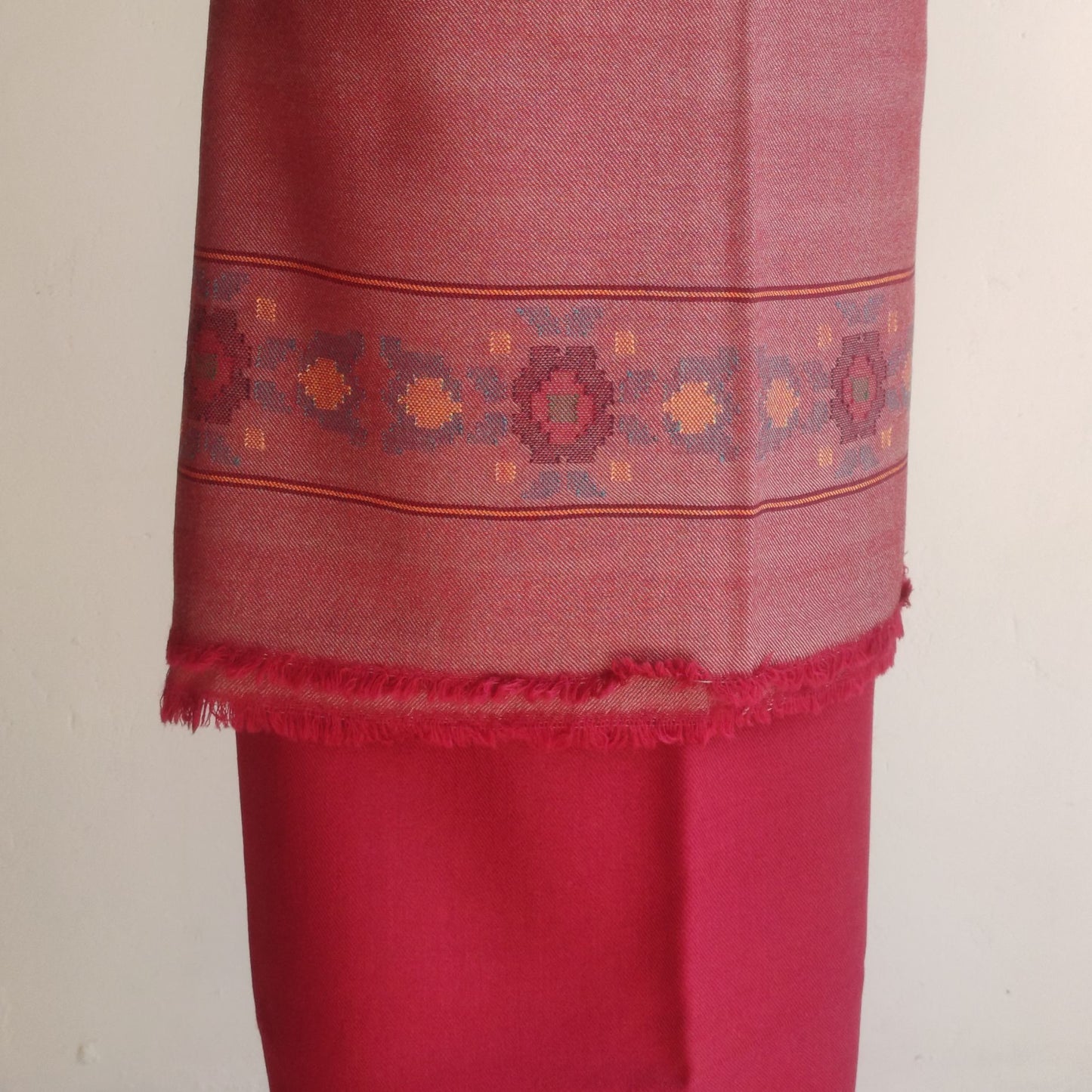 Red women's woolen suit with intricate patterns 