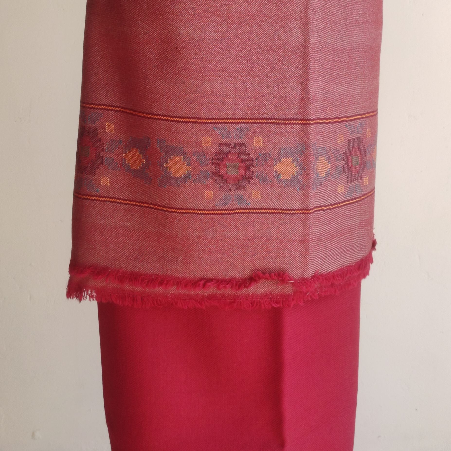 Red women's woolen suit with intricate patterns 