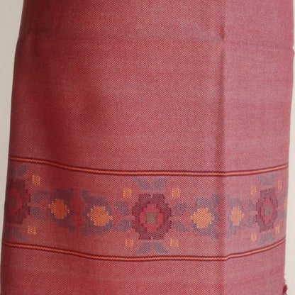 Close-up of a red suit with intricate patterns on a plain background
