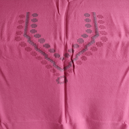 Close-up of a pink woolen suit fabric with geometric embroidery patterns