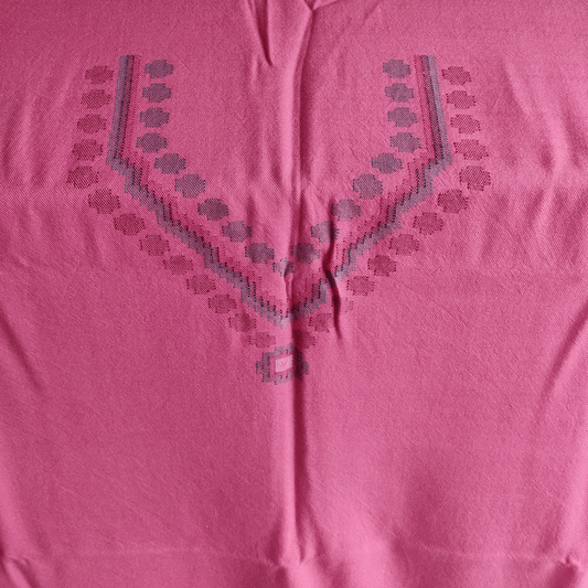 Close-up of a pink woolen suit fabric with geometric embroidery patterns