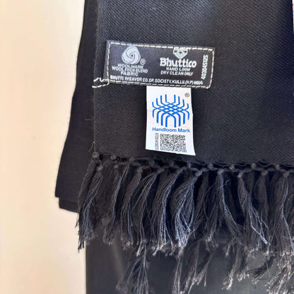 Black scarf with Bhutto label and Handloom Mark on a beige background