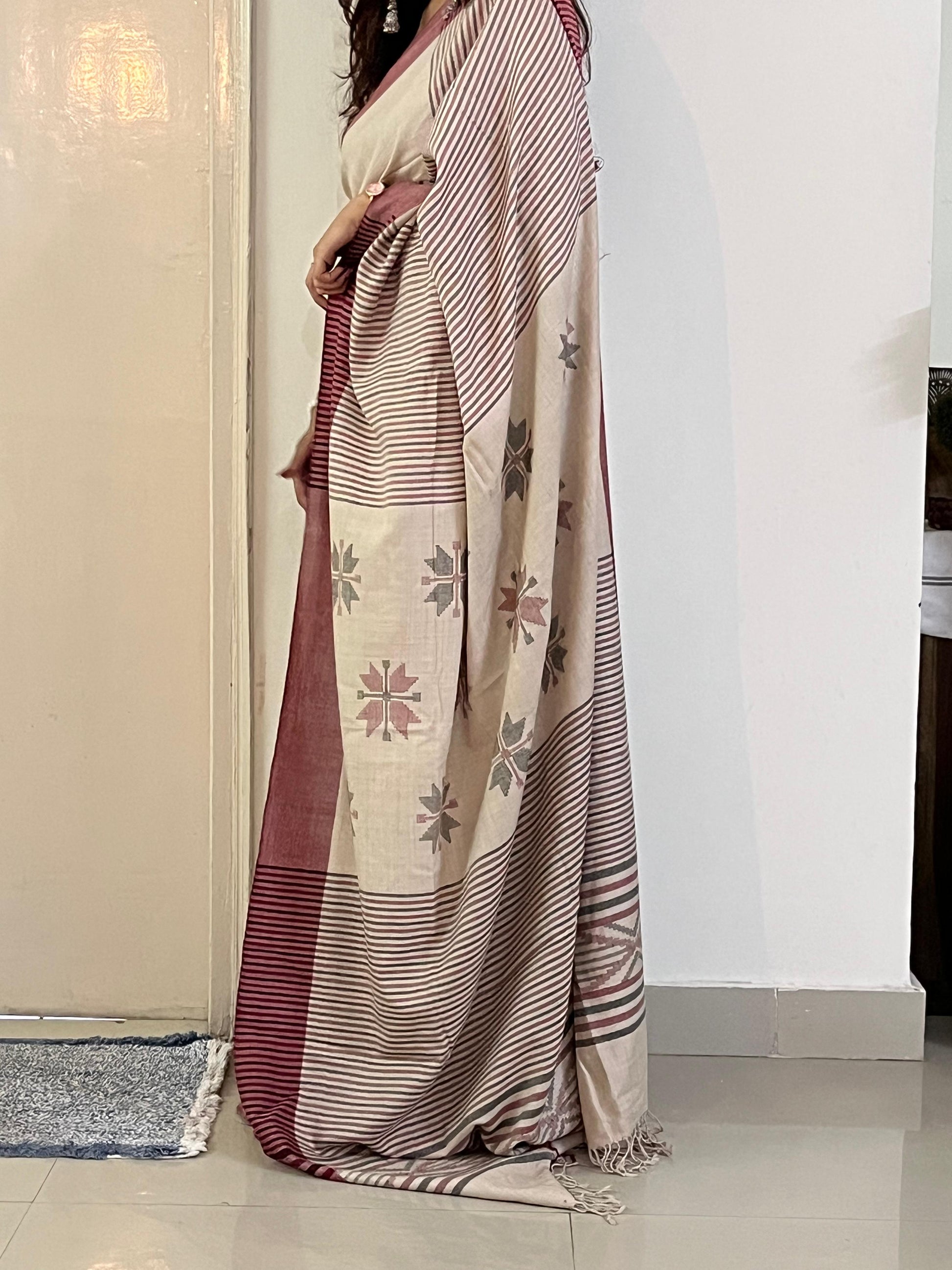 Woman wearing a cream handwoven merino wool saree - pallu and border detail view