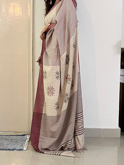 Woman wearing a cream handwoven merino wool saree - pallu and border detail view